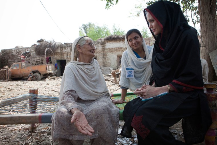 Image: Actress Angelina Jolie meets 64-year-old Zenul Hawa at her flood damaged home in the village of Mohib Bandi